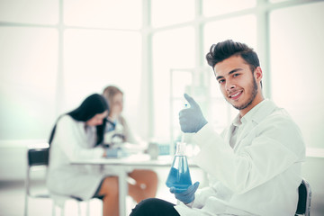 Fototapeta premium smiling young scientist researching a coronavirus vaccine