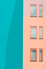Fototapeta na wymiar Pastel-hued building with windows. Minimal Aesthetic. Architectural photography.