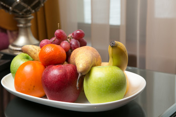 Mixed fruit platter on the table. Shallow dof