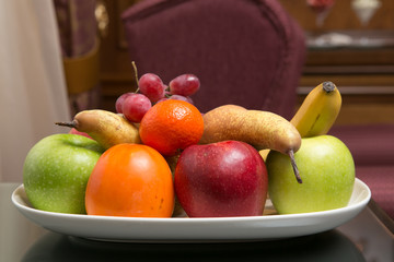 Mixed fruit platter on the table. Shallow dof