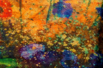 A close-up of a handkerchief with a pattern resembling blue flowers against the background of yellow autumn sheets