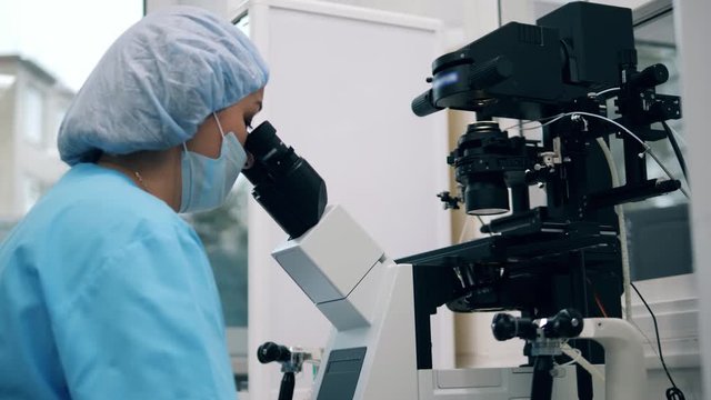 One doctor works with modern microscope in clinic.