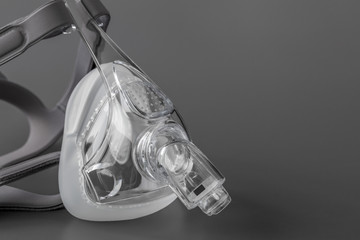 Sleep apnea CPAP mask on the grey background - obrazy, fototapety, plakaty