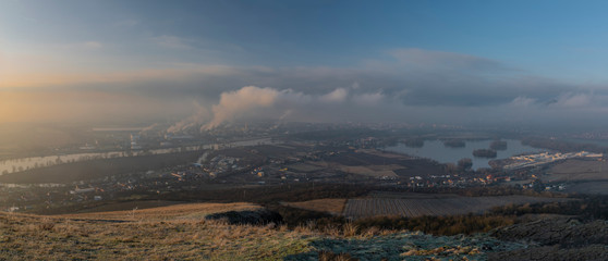 Sunrise time on Radobyl hill over valley of river Labe and Lovosice town