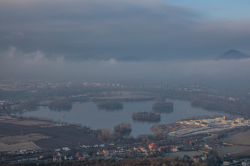Sunrise time on Radobyl hill over valley of river Labe and Lovosice town