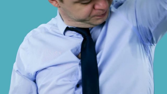 Businessman sweating excessively smelling. Man with Hyperhidrosis sweating very badly under armpit. Hyperthyroidism concept