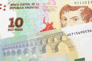 A ten peso bill from Argentina, close up in macro with a red, five Euro European bank note