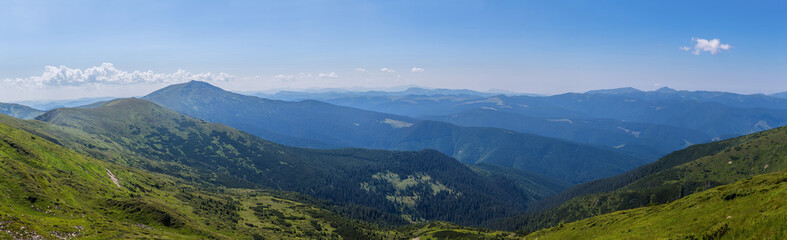 Panorama of green mountains with clouds. Ukraine, Carpathians.