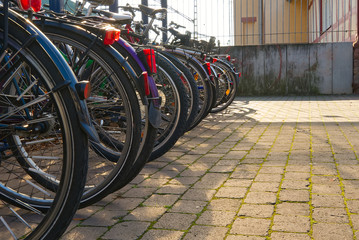 Bicycles are parking at rail station with copy space - obrazy, fototapety, plakaty