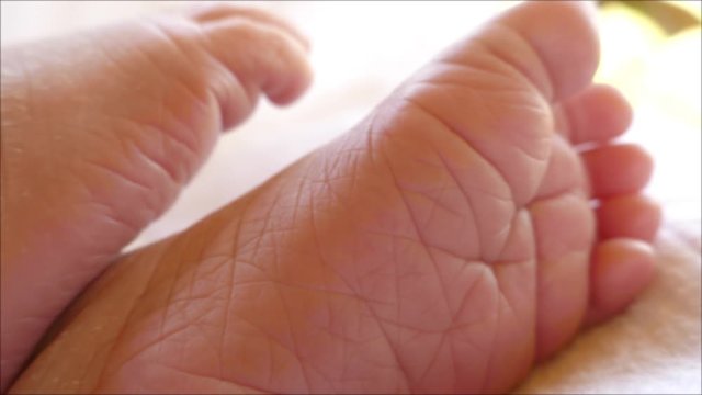 Close up footage of a babies feet, the shot comes into focus and goes out of focus again...
