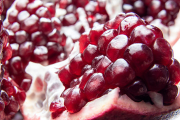 Red Background of Grain Red Grenades. Big Ripe Red Granets or Garnets. Fruits of Red Ripe Pomegranate. Vegetarian Concept, Organic Vitamins. Organic and Benefit Garnet Fruit.