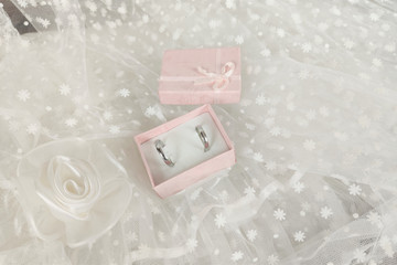 wedding concept. wedding shoes,  rings  on the background of a white veil.