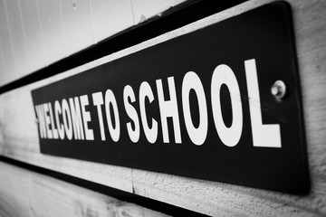 Black and white sign saying Welcome To School