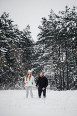 Couple playing with snow in the forest