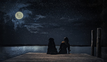 womanwith dog watching moon
