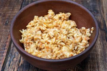 Pilaf with meat. Rice porridge with meat. Clay dishes.