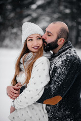 Fototapeta premium Couple playing with snow in the forest