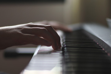 Close-up shot of hands playing piano.