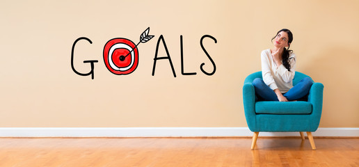 Goal concept with woman in a thoughtful pose in a chair