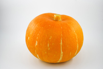 Yellow pumpkin close-up on a white background