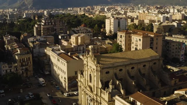 Cinematic flying on an early sunny morning over an old Baroque Church in the historic part of Palermo. Aerial shoot
