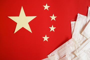 Fototapeta premium Chinese flag on which lie medical masks. 2019-ncov concept