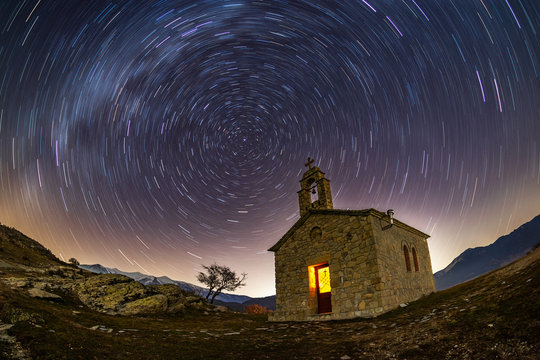 Circular star trails nightscape around an old church