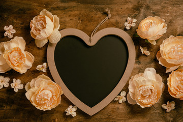 Valentine's Day background. Roses and heart on wooden background. Valentines day concept.