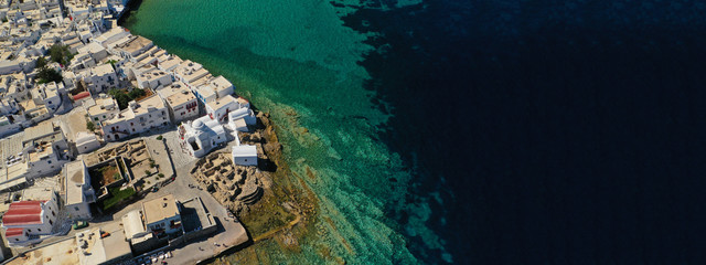 Aerial drone ultra wide photo of famous whitewashed chapel of Paraportiani in Little Venice area,...