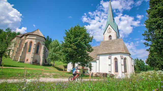 Young couple's bike riding in the countryside exploring surroundings of Lese, Slovenia