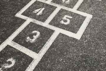 A children's hopscotch game lines painted on the concrete at school