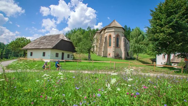 Young couple's bike riding in the countryside exploring the surroundings of Lese, Slovenia
