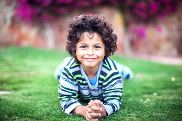 A portrait of smiling kid boy outdoor. Children and emotions concept