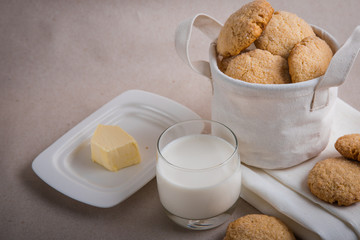 homemade biscuits in a linen basket on a beige background. cracked cookies. Healthy sweets cooking for family.