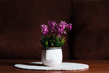 pot of pink flowers on wooden table