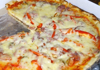 Ready pizza with ham in a hill.