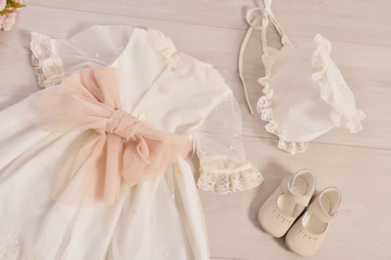 christening baby dress. Close-up of a cute newborn baby dress. Stylish embroidered white dress....