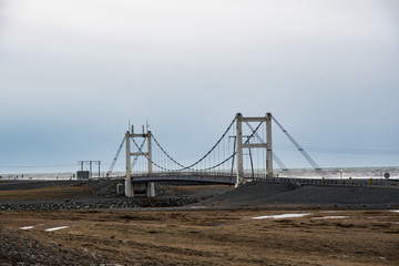 Suspension bridge crossing the river of Jokulsarlon ice Lagoon in south Iceland