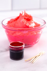 Pot of Gel Food Coloring on a Marble Counter Top