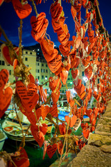 Camogli, Genoa, Italy. Small decorative wooden hearts hanging on a fishing net