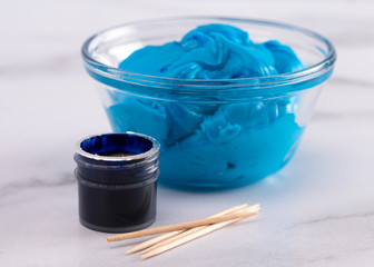 Pot of Gel Food Coloring on a Marble Counter Top