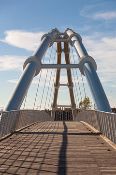 Perspective of a bridge with a blue sky. Image.