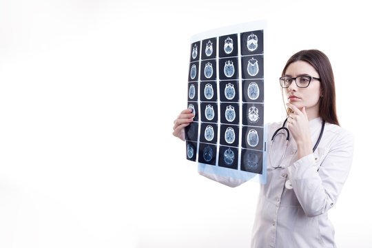 Pensive female physician examining patient's brain tomography film isolated white background copyspace