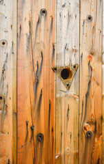 Old weathered wood boards background with knot, bent nails and holes