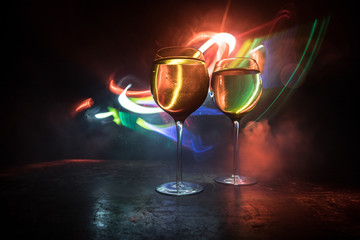 Goblet of white wine on wooden table on wooden wall background