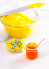 Open Pot of Gel Food Coloring with Dyed Icing and Iced Cookie