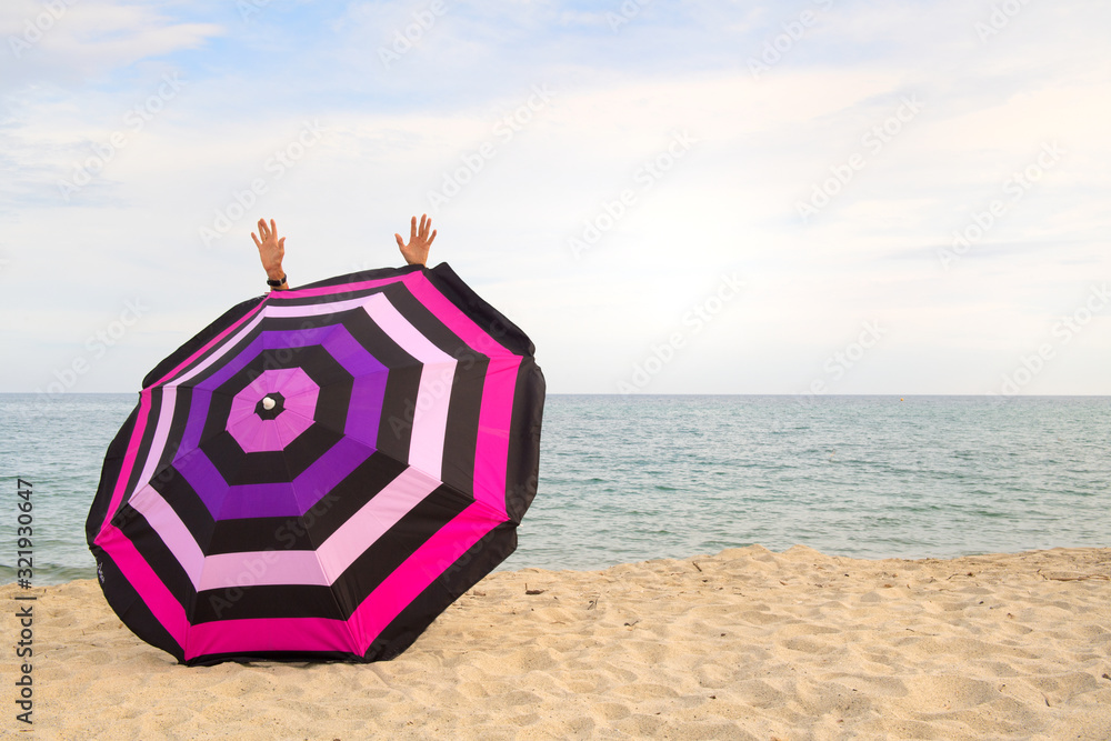 Wall mural Happy at thbe beach behind Beach umbrella for shadow