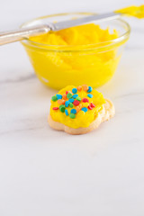 Cookies Decorated with Bright Yellow Colored Frosting with Fun Sprinkles