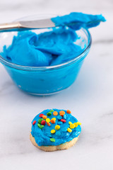Cookies Decorated with Bright Blue Icing and Colorful Sprinkles