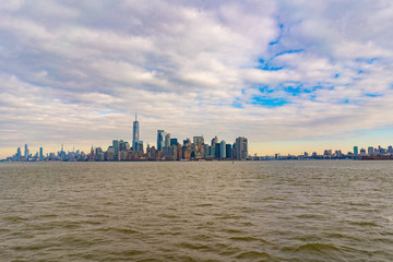 Statue of liberty with panorama of manhattan and jersey city, new york city
